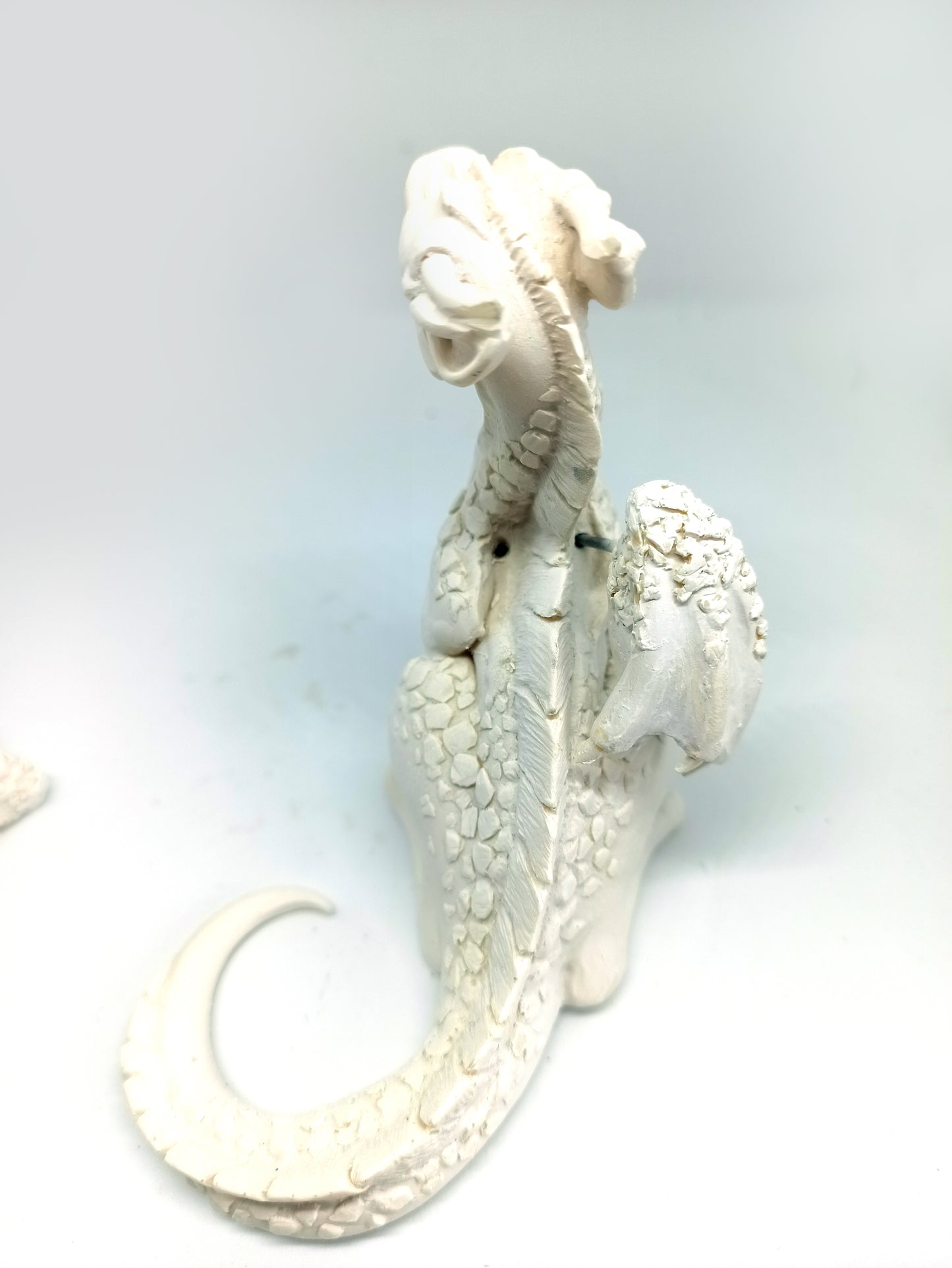 Unpainted sitting down dragon figurine to customize