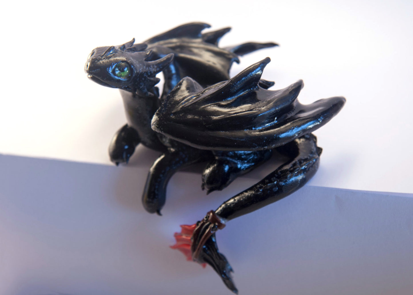 Black dragon laying down unique figurine