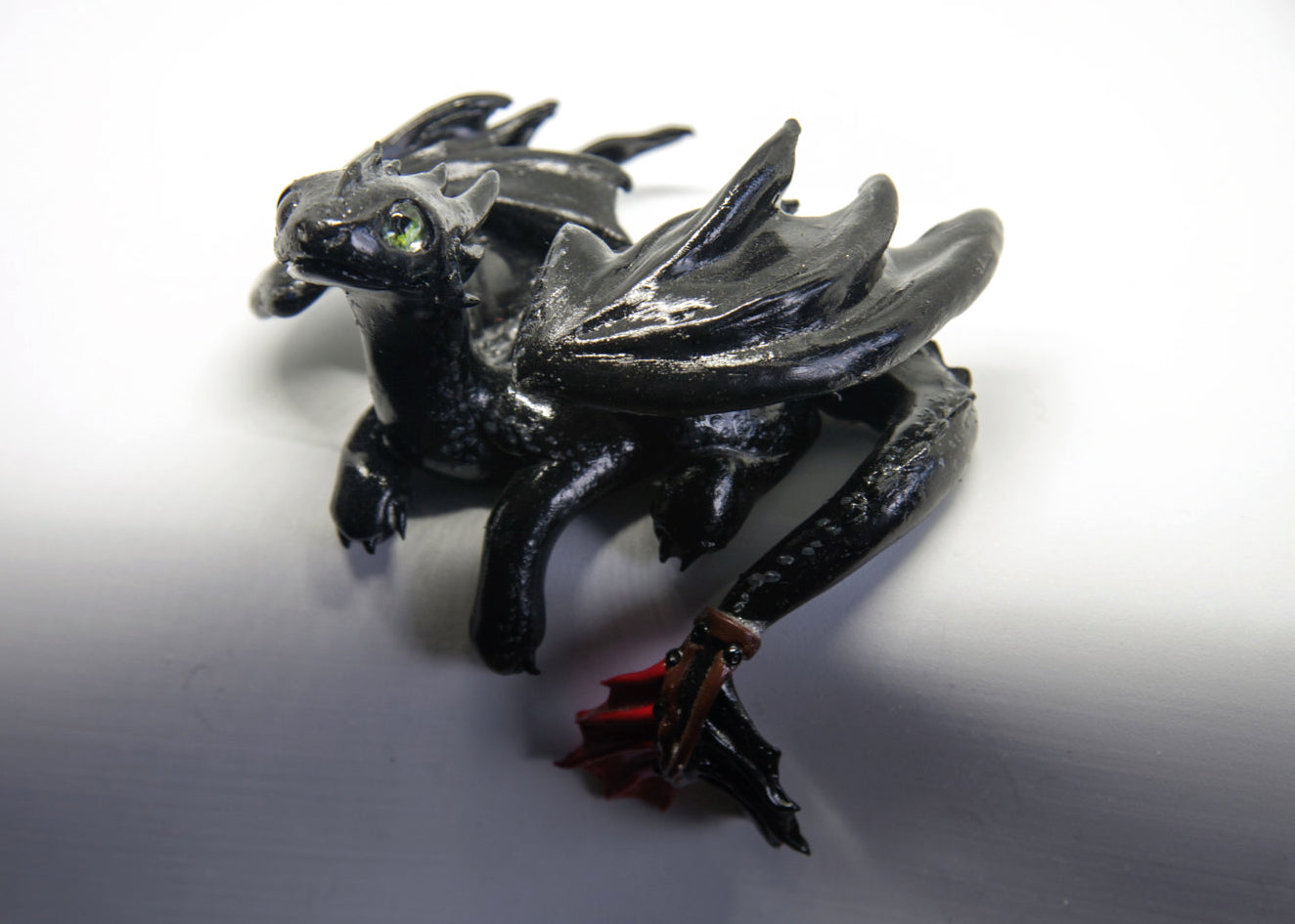 Black dragon laying down unique figurine