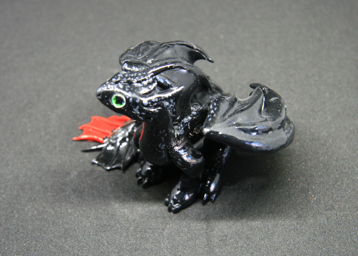 Black dragon sitting down unique figurine