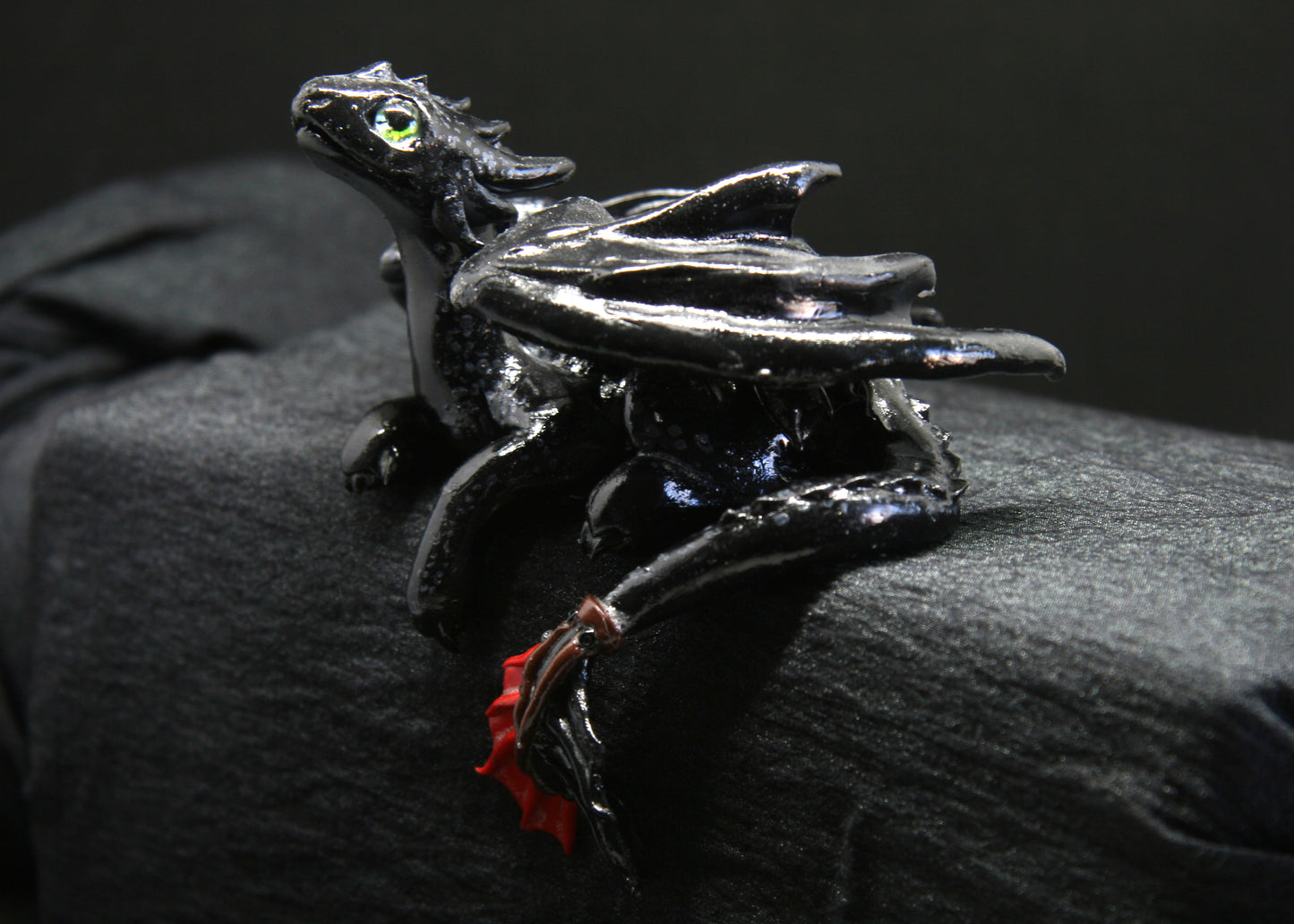 Black dragon laying down unique figurine