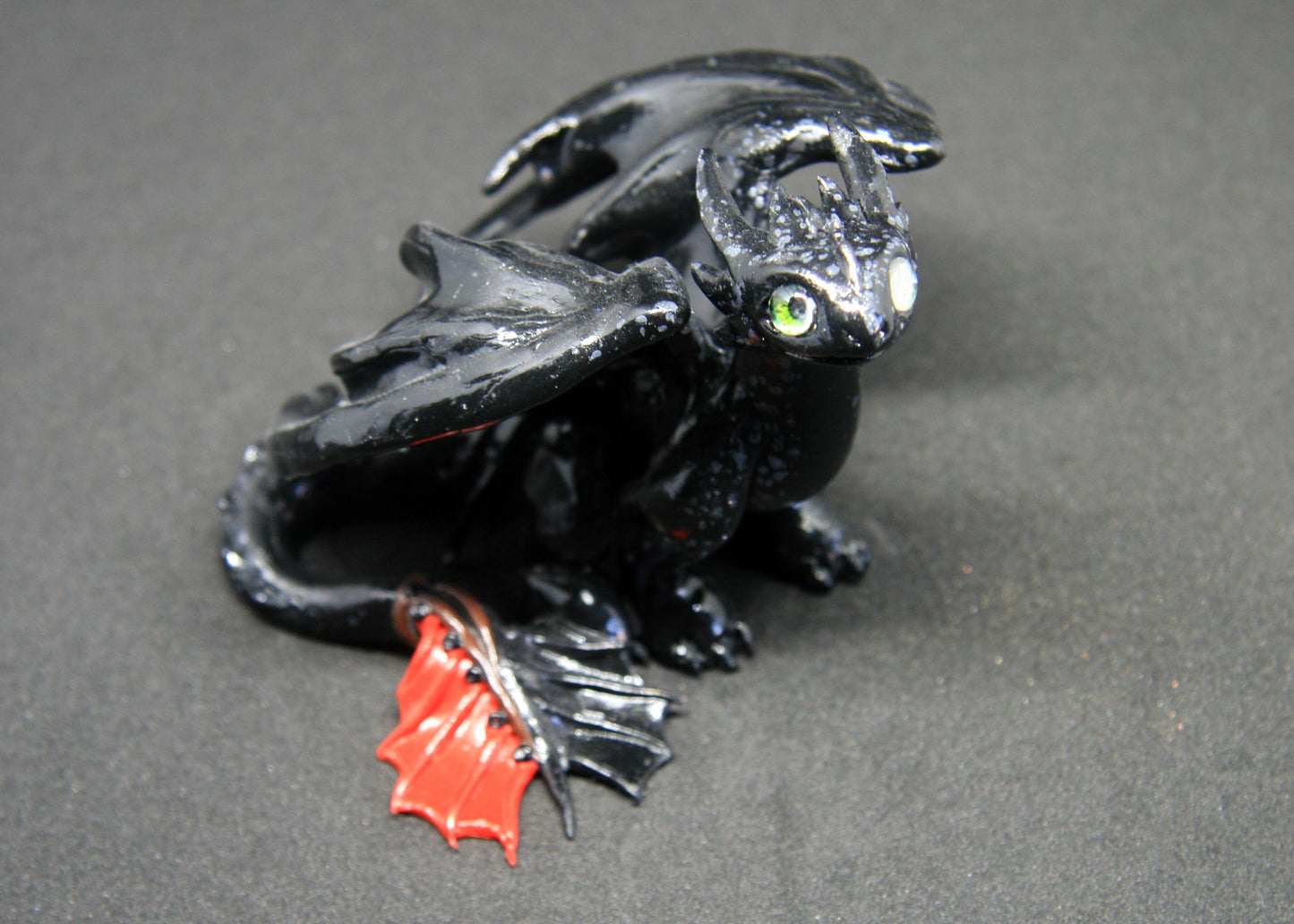 Black dragon sitting down unique figurine