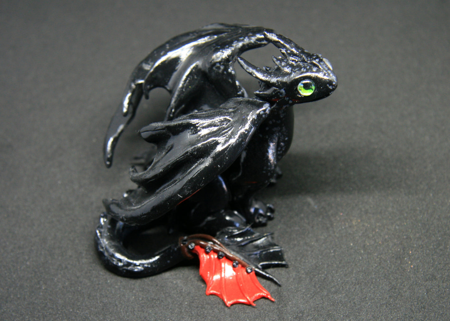 Black dragon sitting down unique figurine