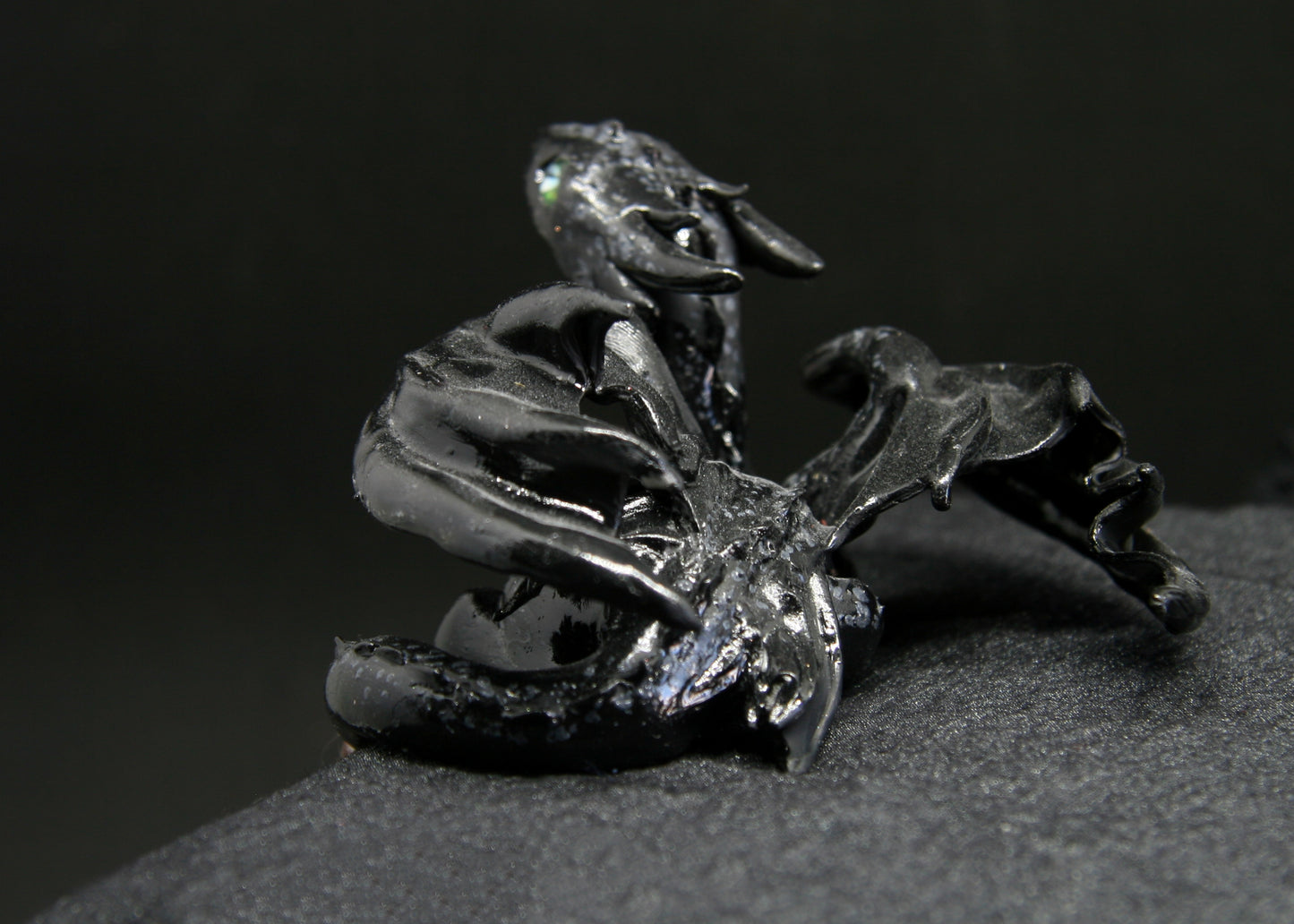 Black dragon laying down unique figurine