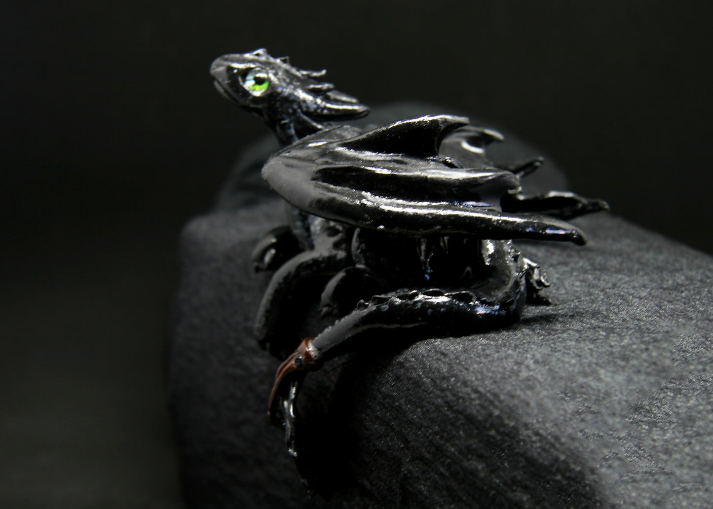 Black dragon laying down unique figurine