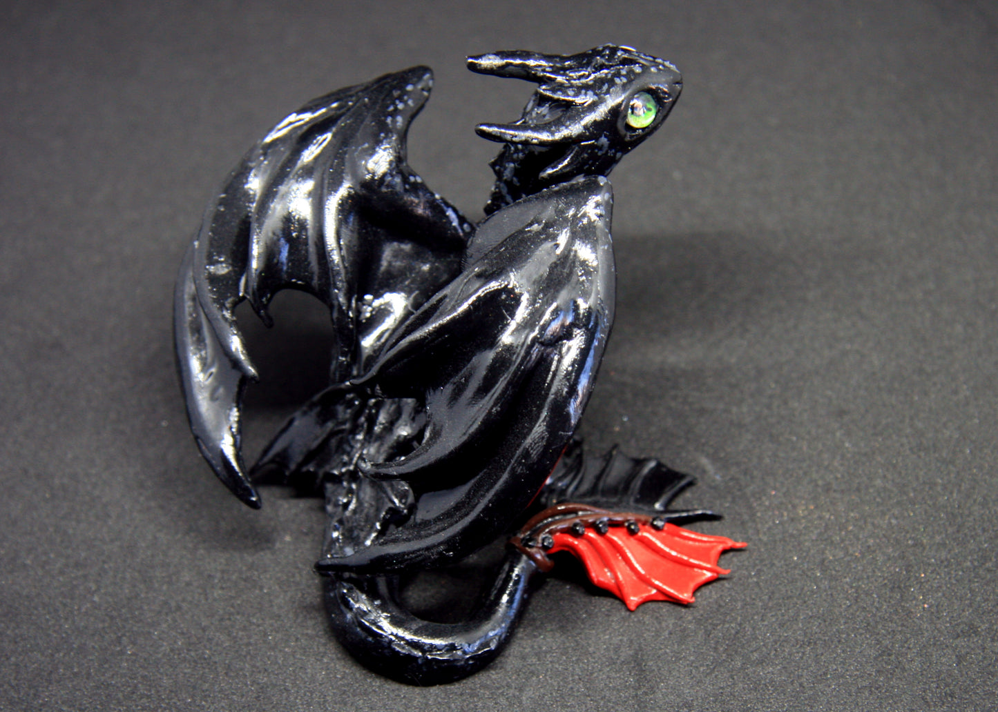 Black dragon sitting down unique figurine