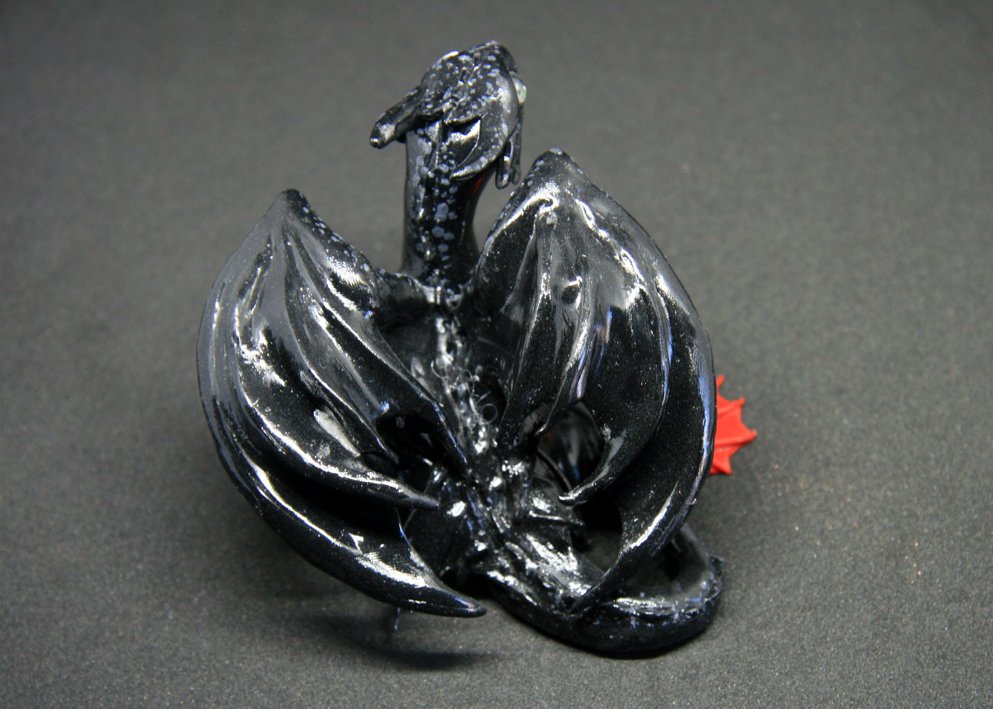 Black dragon sitting down unique figurine