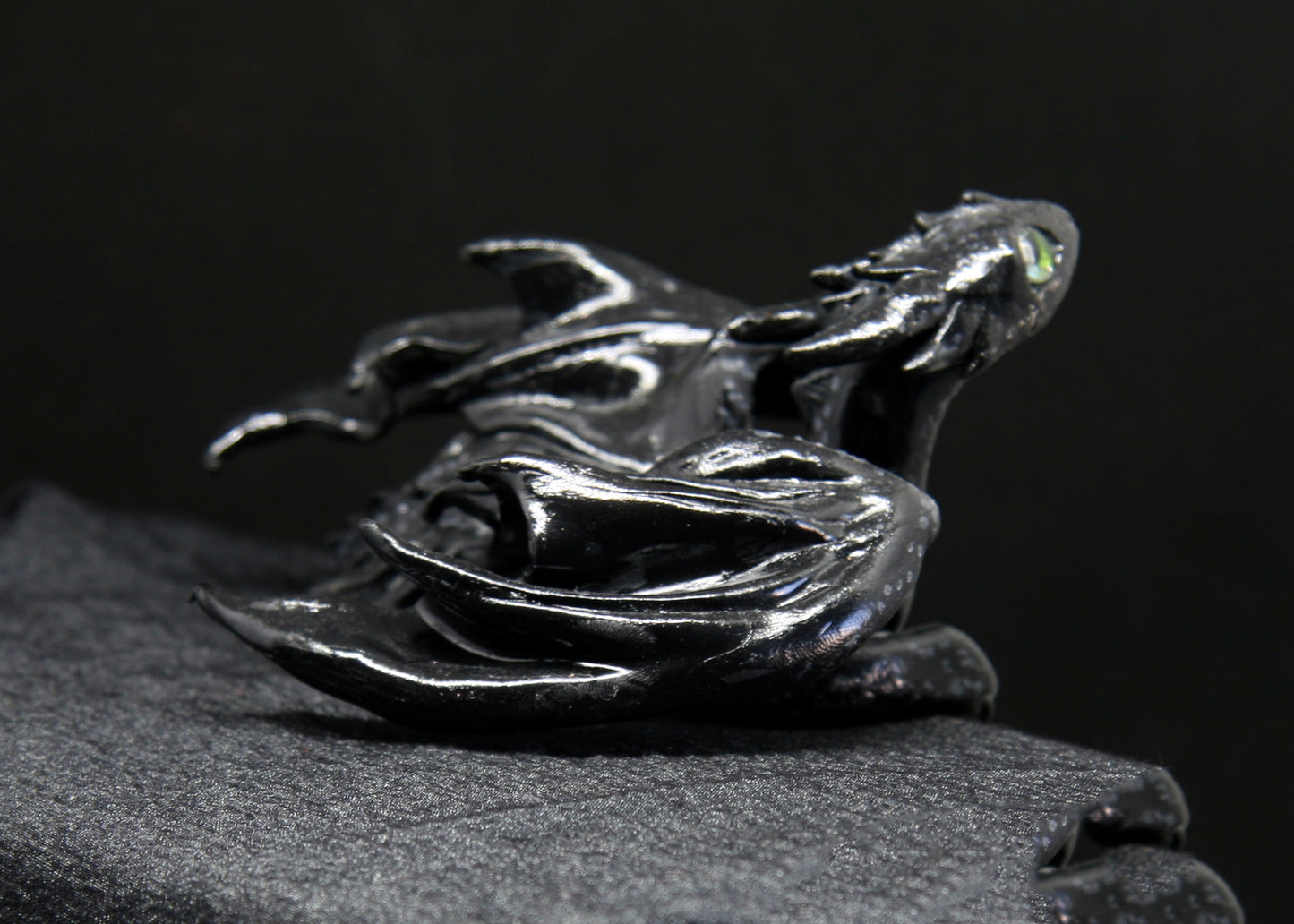 Black dragon laying down unique figurine