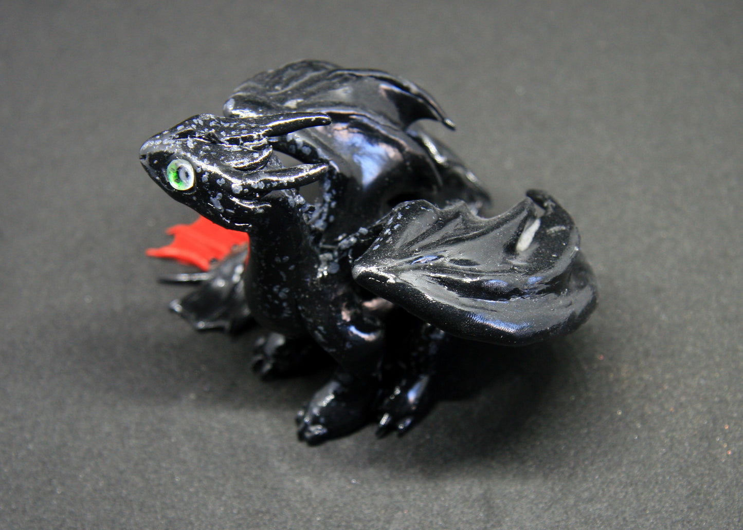 Black dragon sitting down unique figurine