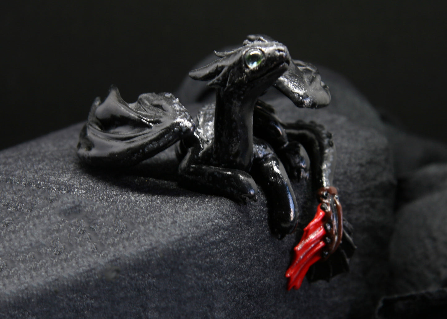 Black dragon laying down unique figurine