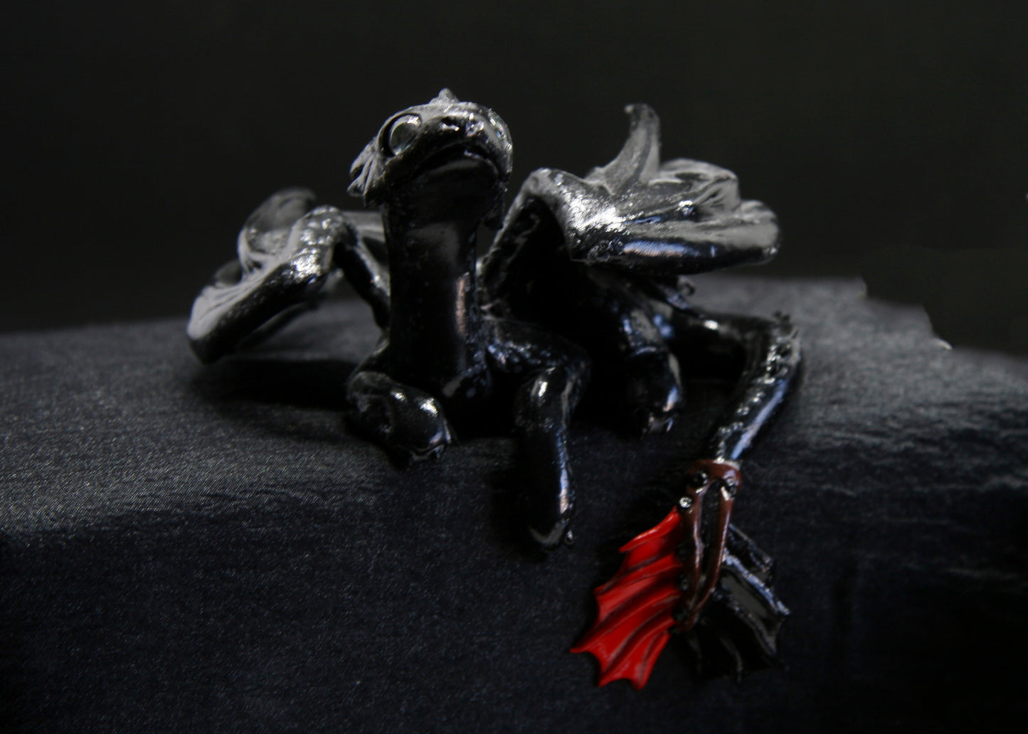 Black dragon laying down unique figurine