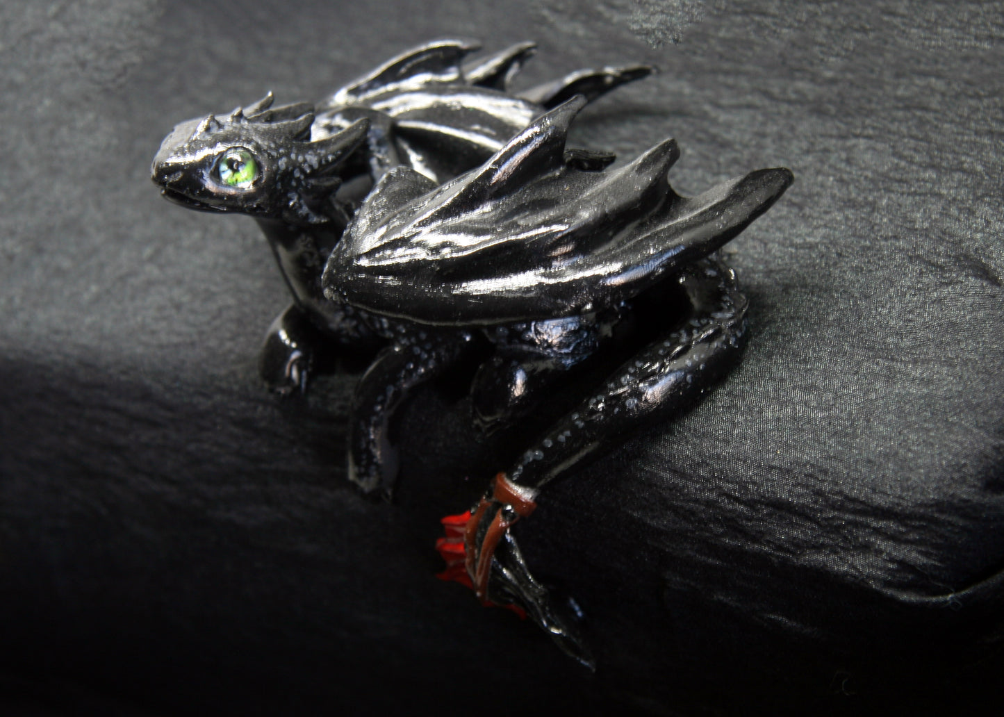 Black dragon laying down unique figurine