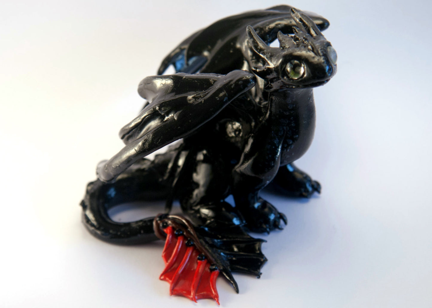 Black dragon sitting down unique figurine