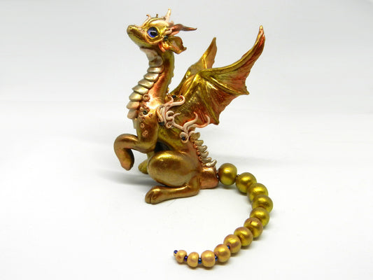 Light gold unique figurine with moveable tail