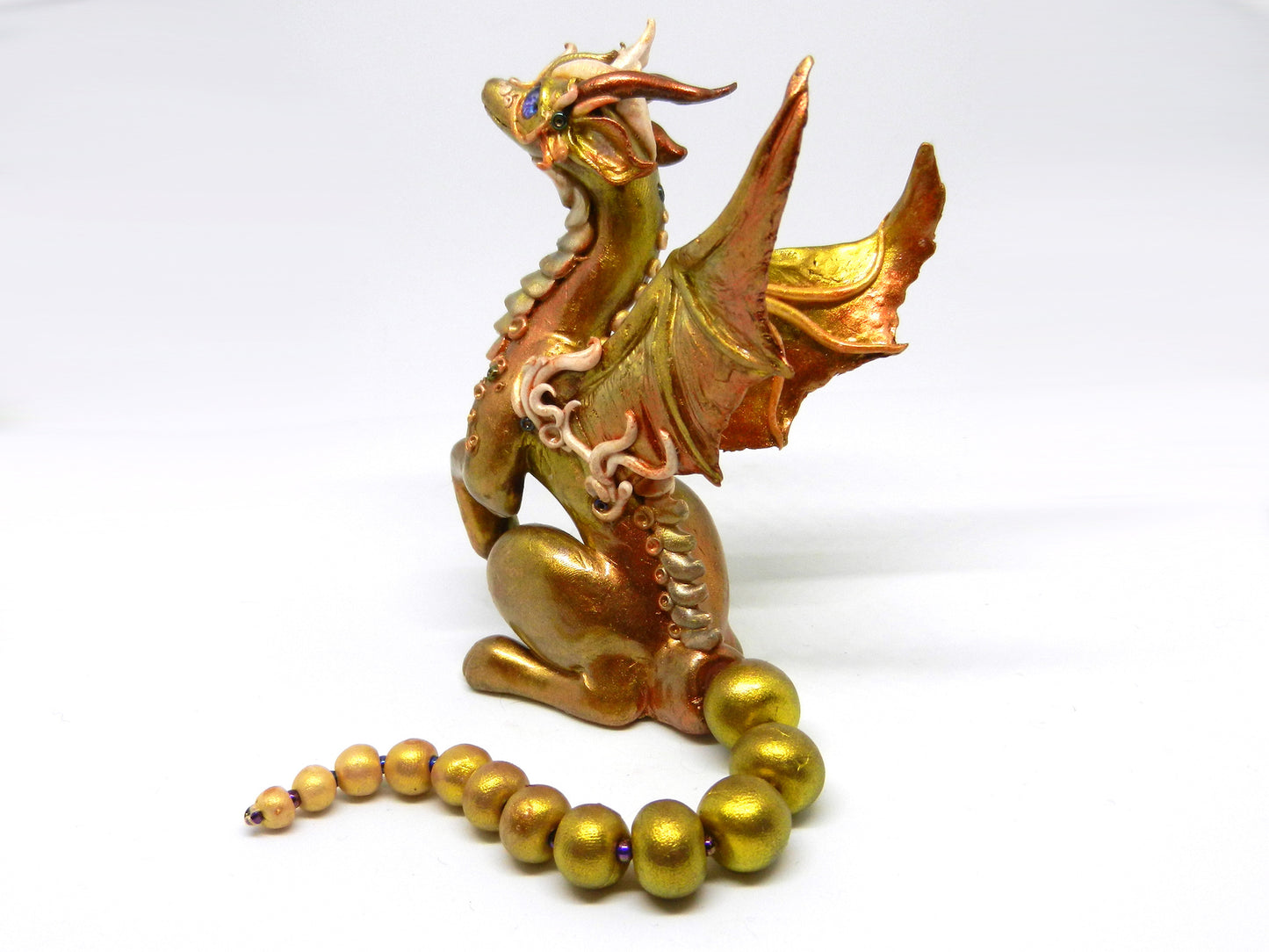 Light gold unique figurine with moveable tail