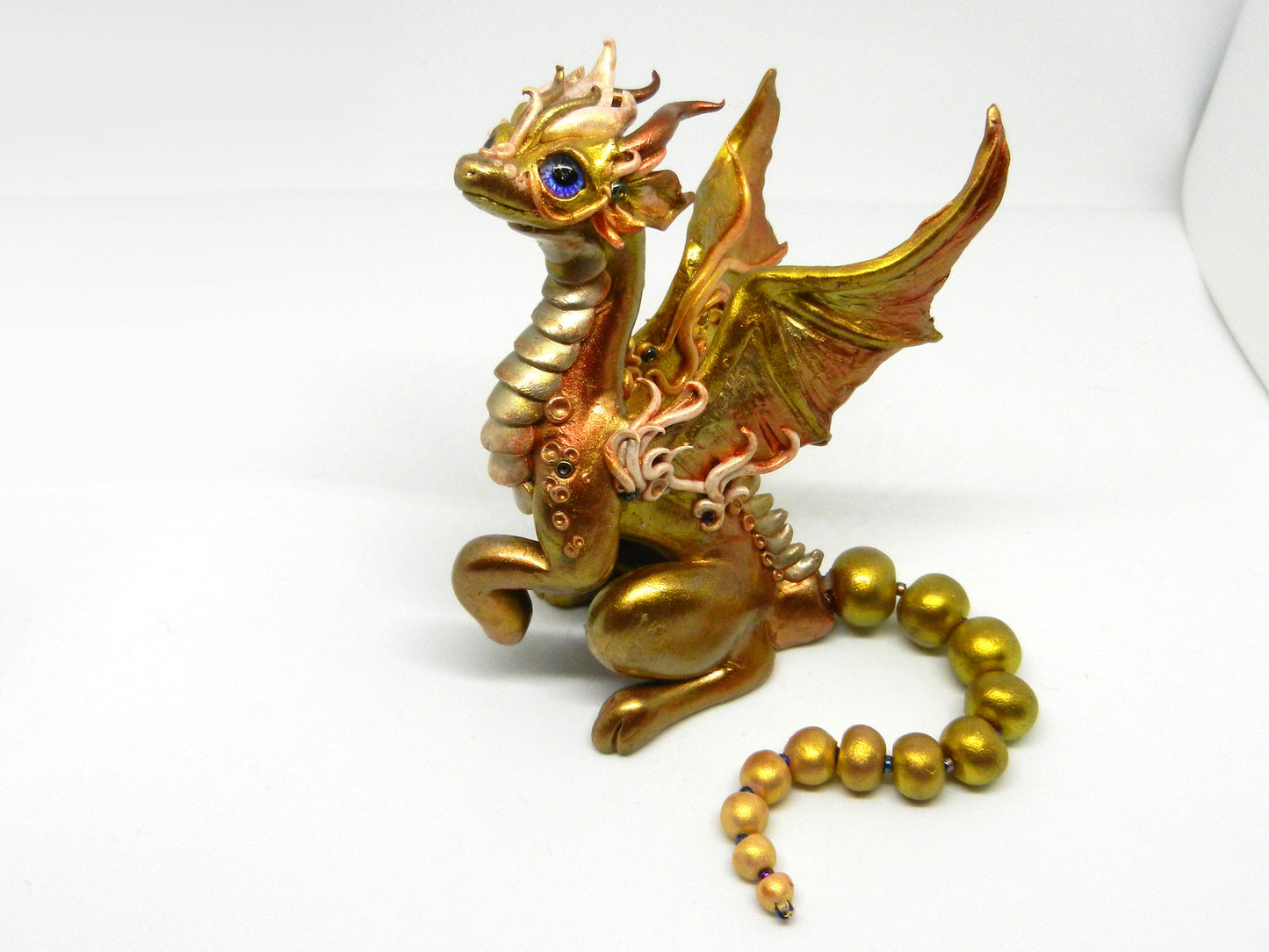 Light gold unique figurine with moveable tail