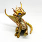 Light gold unique figurine with moveable tail