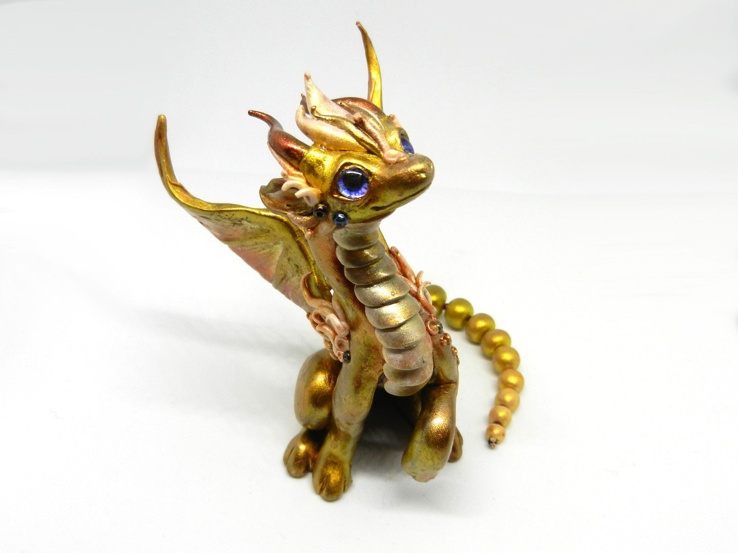 Light gold unique figurine with moveable tail