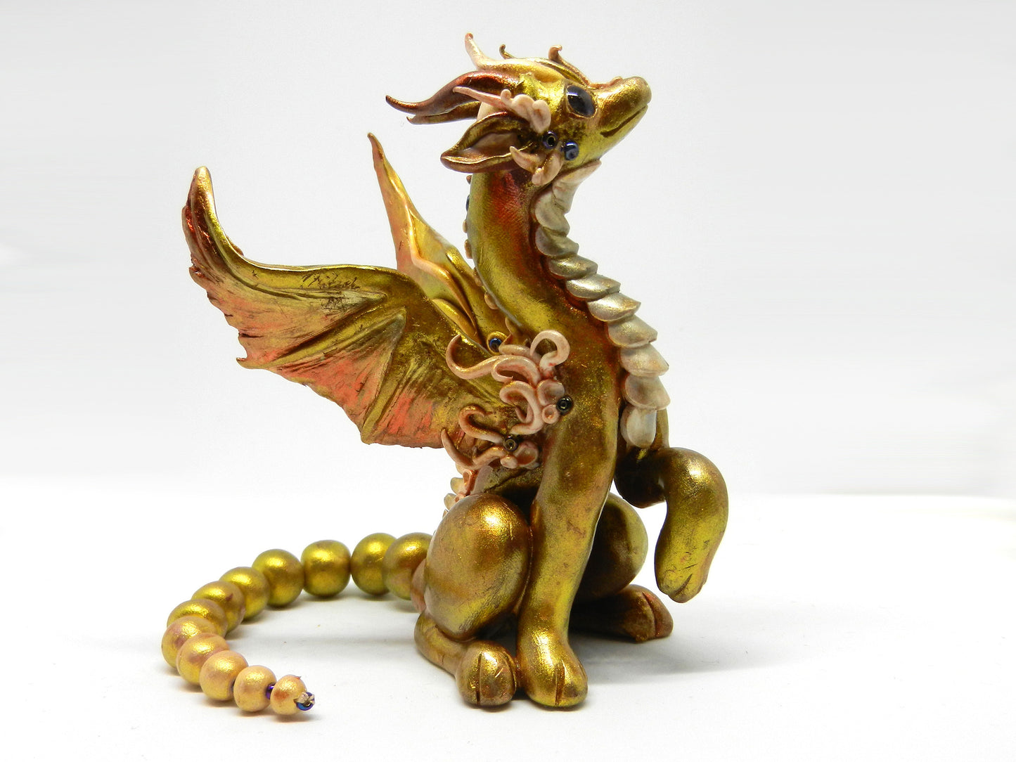 Light gold unique figurine with moveable tail