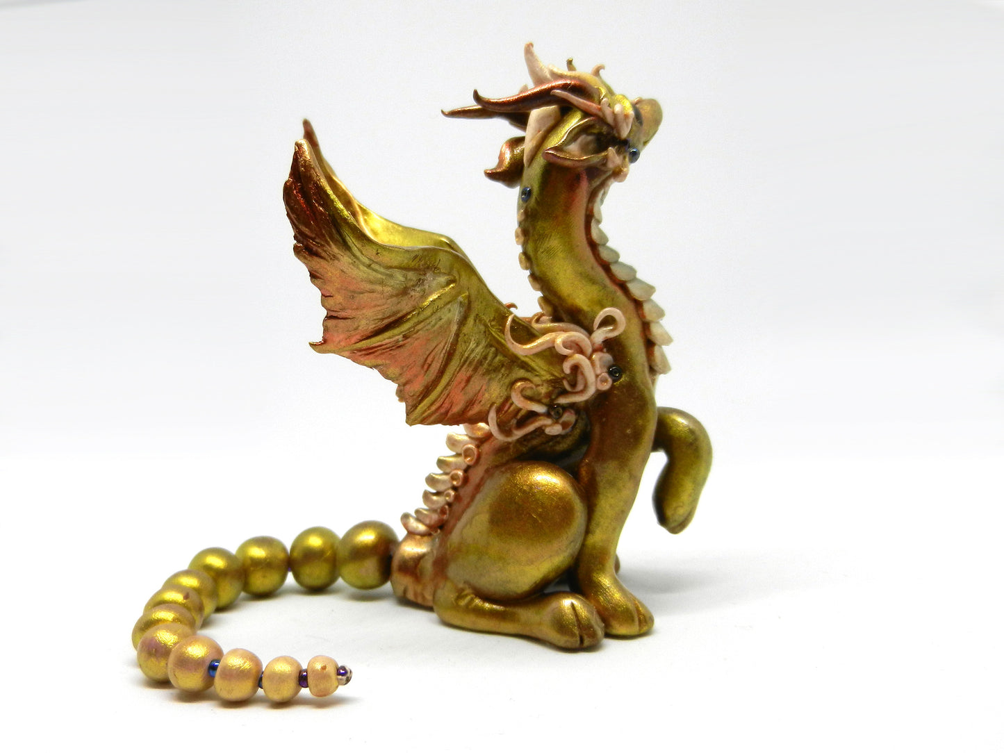 Light gold unique figurine with moveable tail