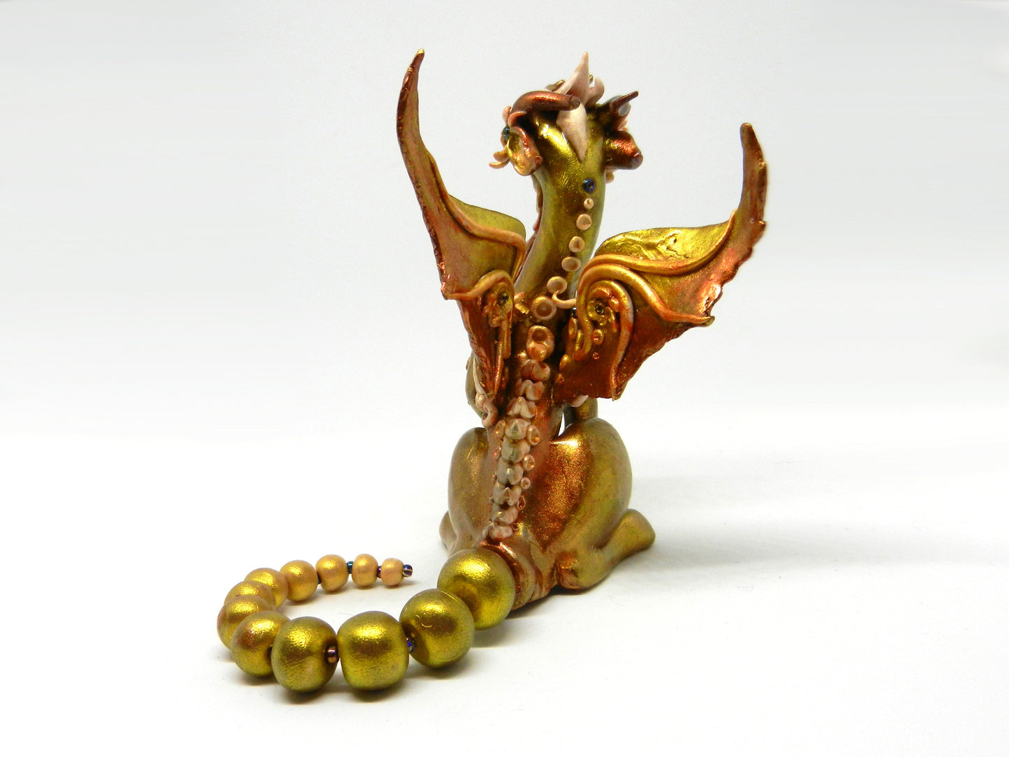 Light gold unique figurine with moveable tail