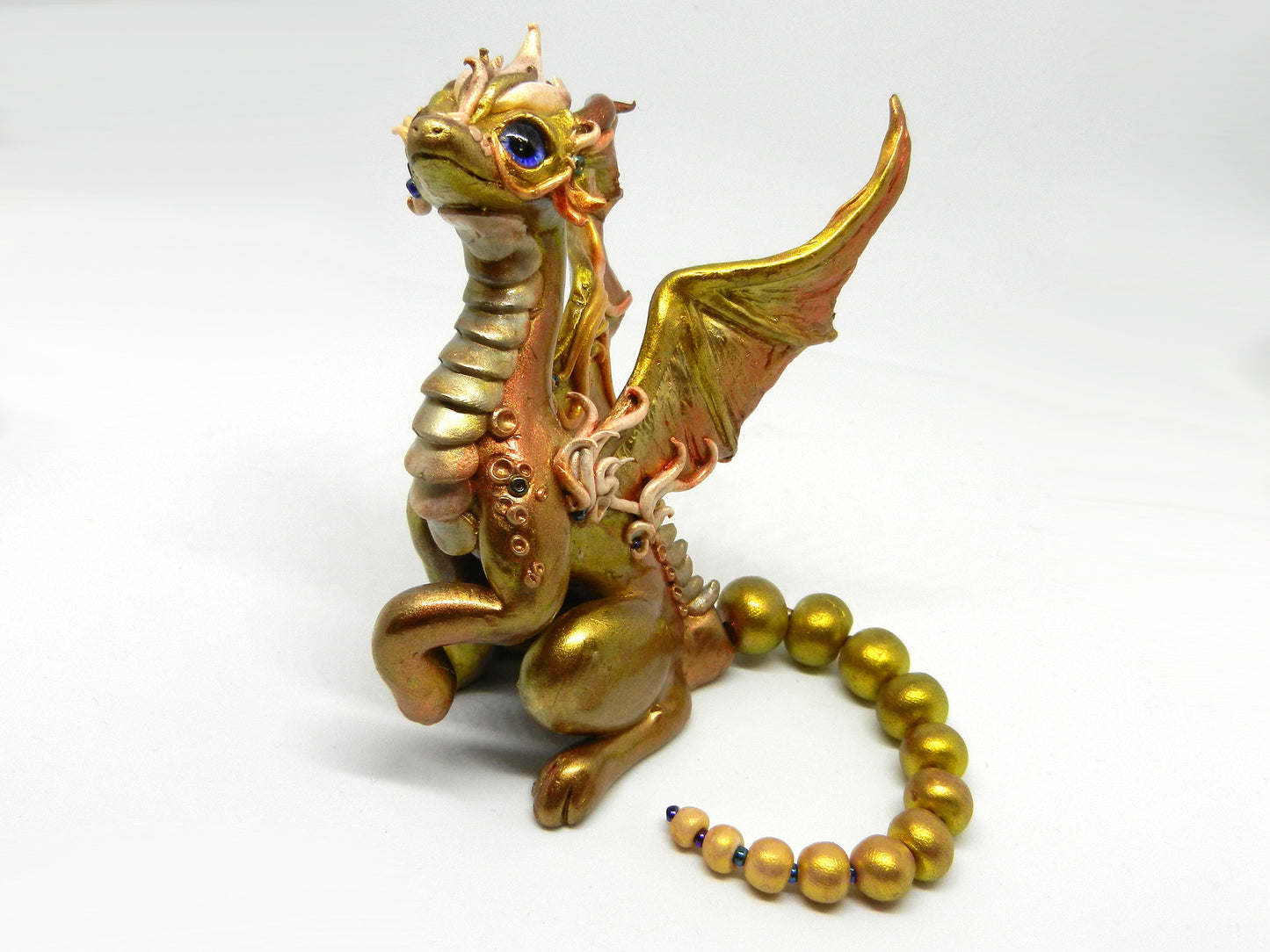 Light gold unique figurine with moveable tail