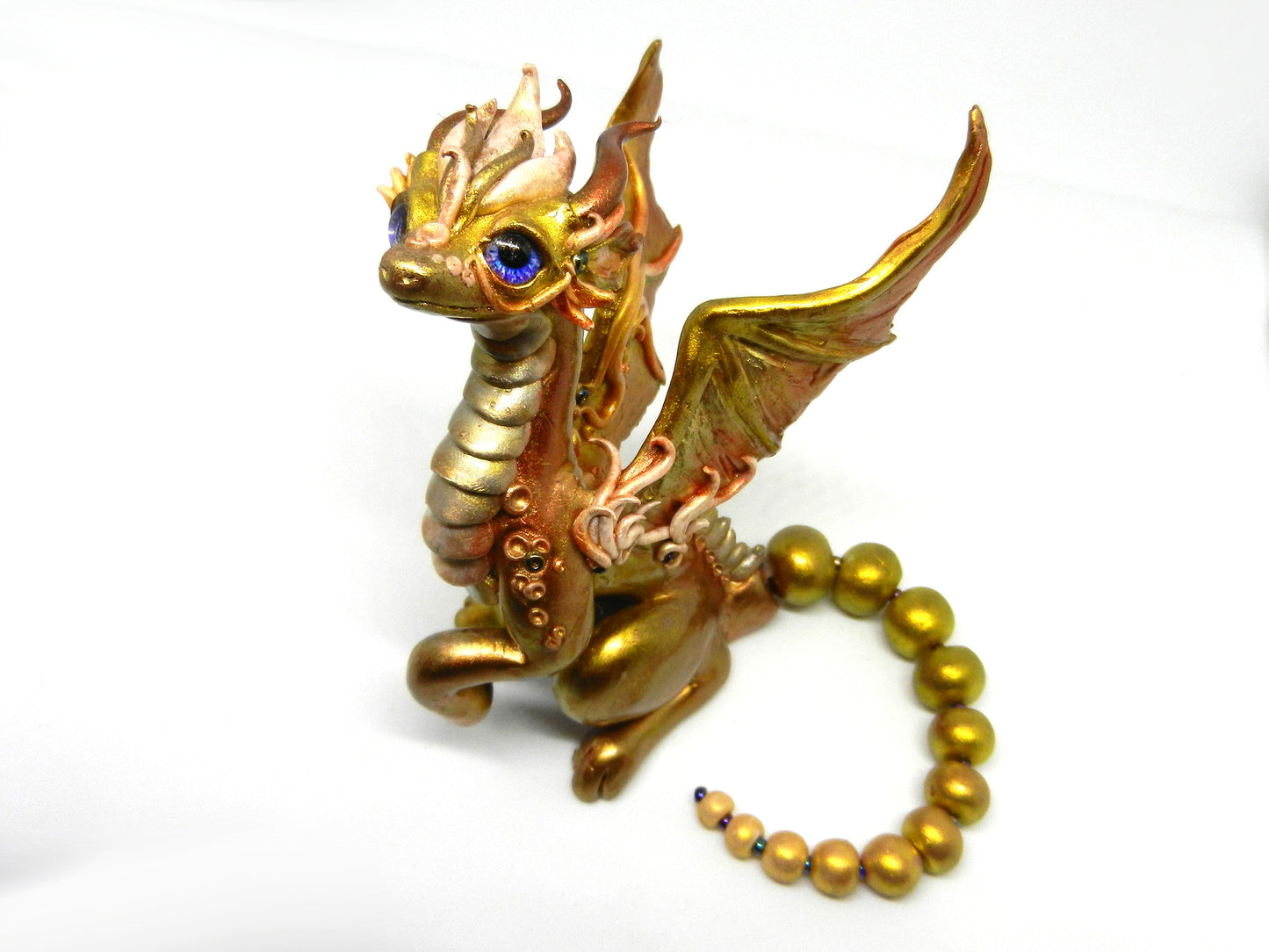 Light gold unique figurine with moveable tail