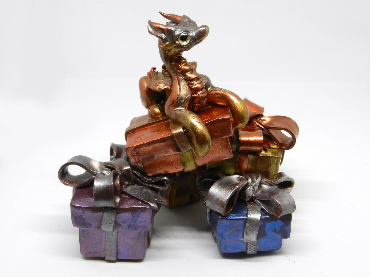 Baby dragon on top off pile of presents unique figurine