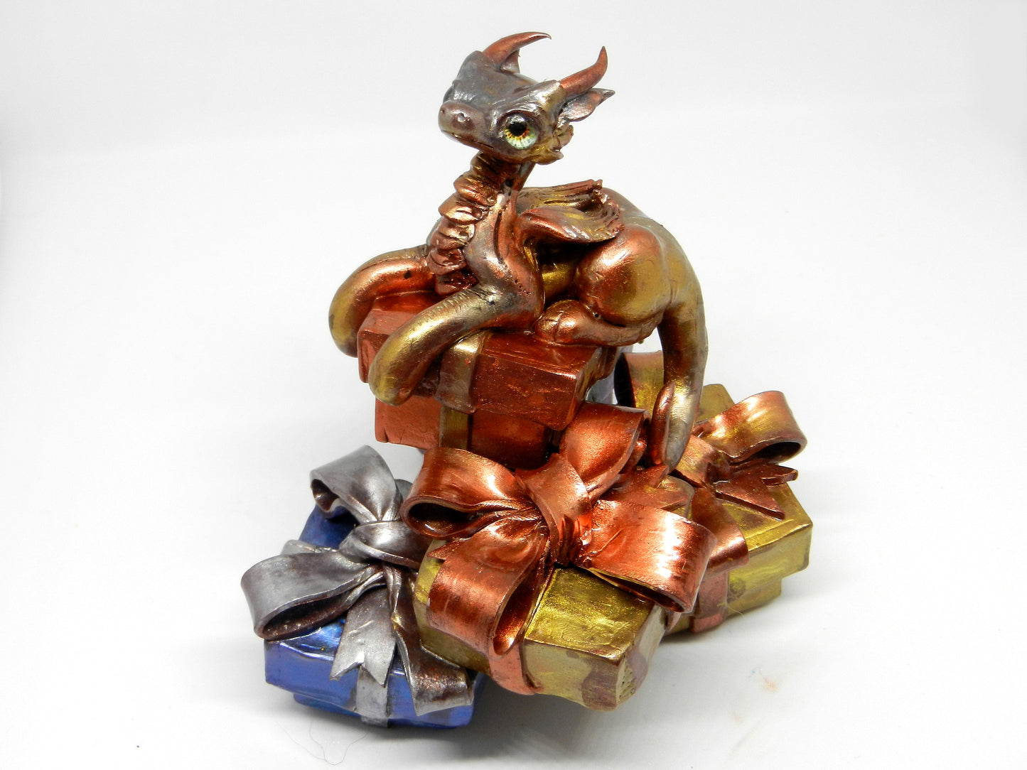 Baby dragon on top off pile of presents unique figurine