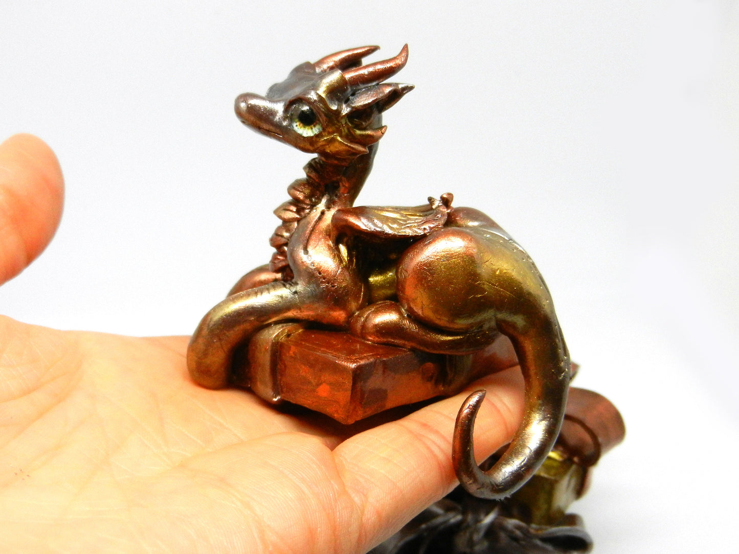 Baby dragon on top off pile of presents unique figurine