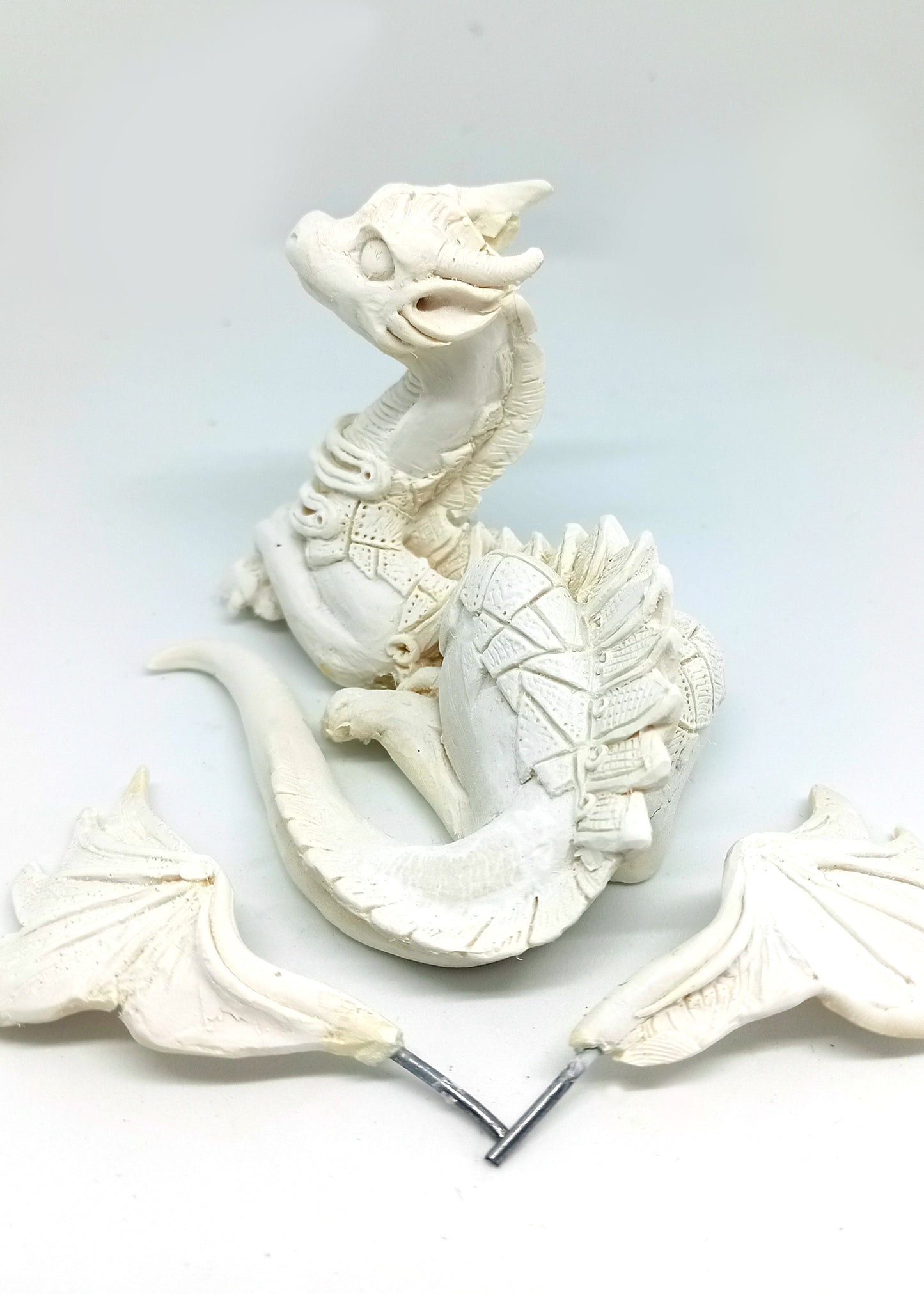 Unpainted laying down dragon figurine to customize