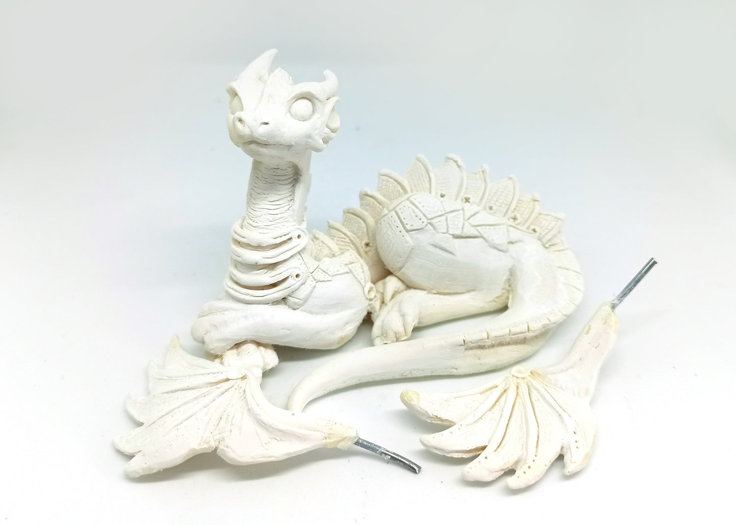 Unpainted laying down dragon figurine to customize